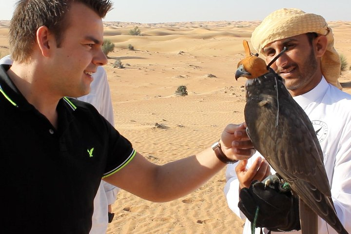 Experience the magic of falconry in the stunning Dubai Desert where personal interactions with these majestic birds come alive amidst breathtaking dunes and expert guidance from seasoned falconers.